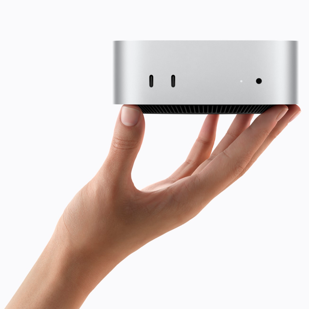 M6 Mac mini held in a hand